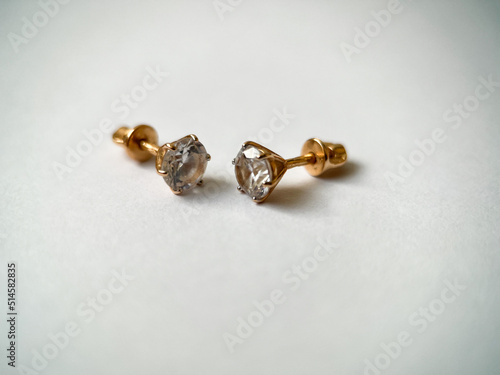 Gold stud earrings with cubic zirconia close-up