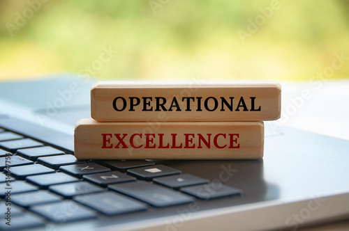 Operational excellence text on wooden blocks on top of a laptop. Business concept