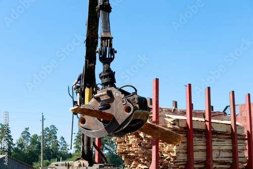 Manipulator for loading or unloading lumber and boards close-up. wood processing industry