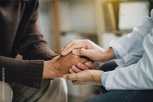 Close-up of psychiatrist hands together holding palm of her patient. comforts an anxious depression patient for medical treatment in diagnostic room, PTSD Mental health concept