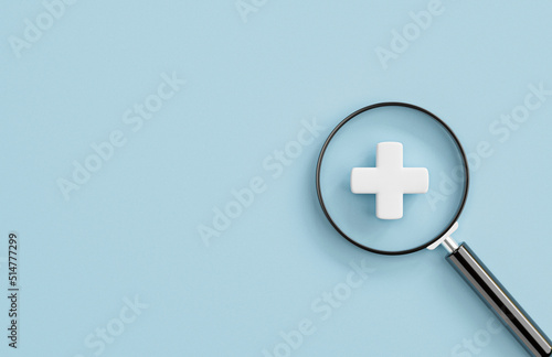 White plus sign inside of magnifier glass with copy space for focus positive mindset , Healthcare and value added concept by 3d render illustration.