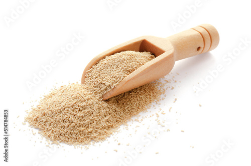 Dry yeast in wooden spoon isolated on white background. Dry granulated yeast in a wooden spoon on a white background. Dry yeast in wooden spoon isolated on white background, close-up.