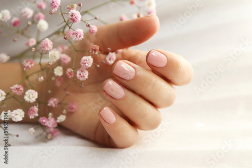 Light pink manicure on short nails with Gypsophila.