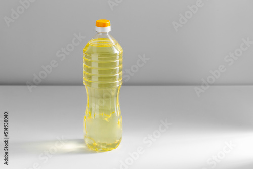 storage, food and culinary concept - close up of cooking rapeseed oil in plastic bottle on table