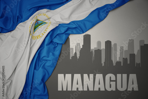 abstract silhouette of the city with text Managua near waving national flag of nicaragua on a gray background. 3D illustration