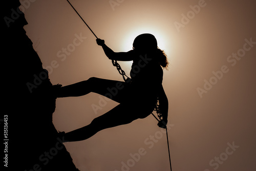 Silhouette of successful young female climber in the mountains Concept of self-improvement, motivation, movement inspiration, motivational goals.Adventurer, mental strength and physical health concept