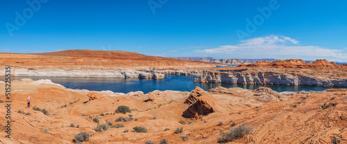 A tourist looking at record low water level Lake Powell .Shot June 2022