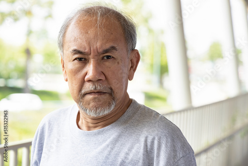 Angry asian senior man staring at you