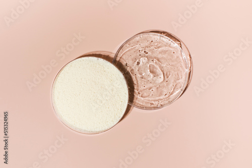 Samples of collagen powder and hyaluronic acid in Petri dishes on a pink background close-up view from above