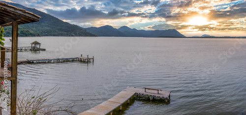 Panoramic view of Lagoa da Conceicao in Florianopolis, Brazil - Rustic houses and wooden piers on the water's edge.