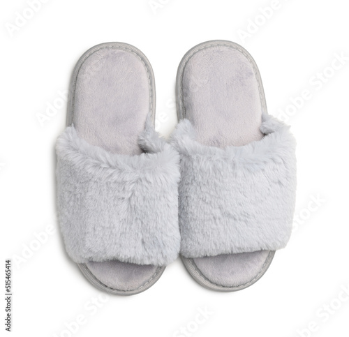 Pair of soft fluffy slippers on white background, top view