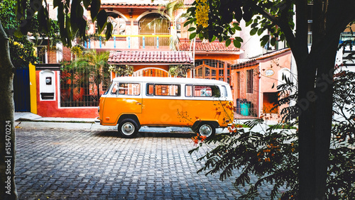 orange westfalia kombi combi parked in tropical beautiful summer paradise for van lifers 