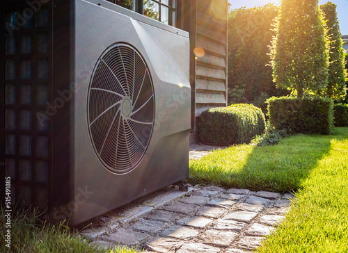 Air heat pump near pool house outdoors.