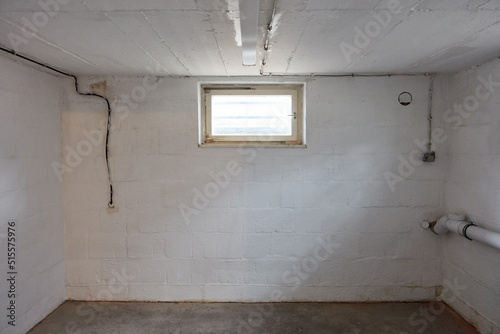 Empty room in the basement with a window as a boiler room