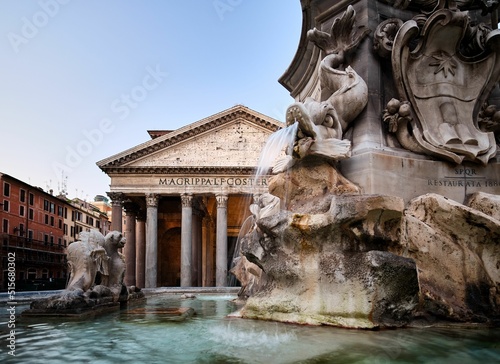 The Pantheon temple in Rome with a historical fountain in the front