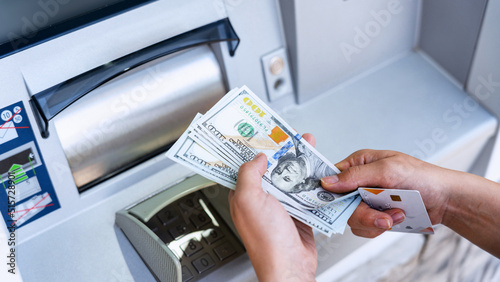 Atm machine money cash. Woman withdraw money bill. Holding american hundred dollar cash. Bank credit card and dollar bill.