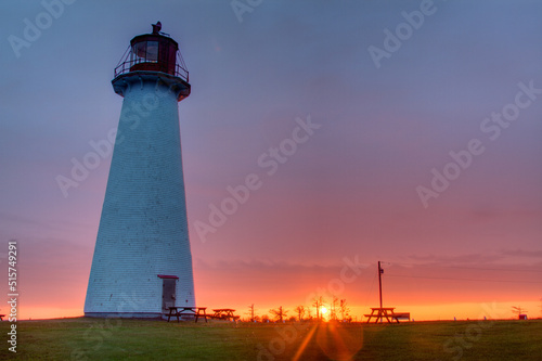 round lighthouse with purple sunset