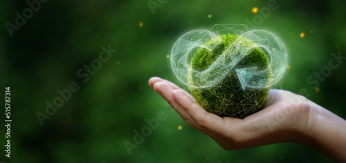 businessman holding circular economy icon Circular economy concept for future business growth and environmental sustainability and reduce pollution for future business and environmental growth.