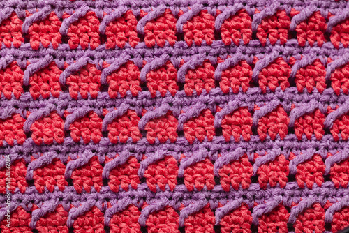 Pink purple seamless knitted texture. Volumetric crochet striped pattern. Knitted background.
