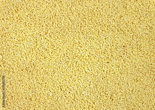 Yellow Soy lecithin granules top view. dietary supplements. Healthy nutrition concept. Soy Bean Lecithin with Plastic Spoon close up.