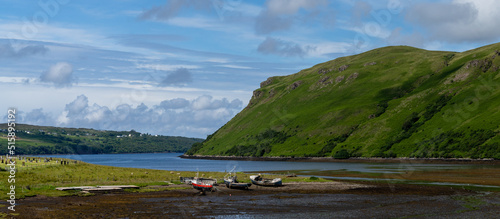 colorful stranded fishing boats at low tide in Loch Harport on the picturesque west coast of the Isle of Skye