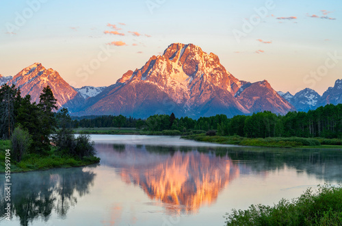 landscape of snow mountain reflecting in the lake in the morning