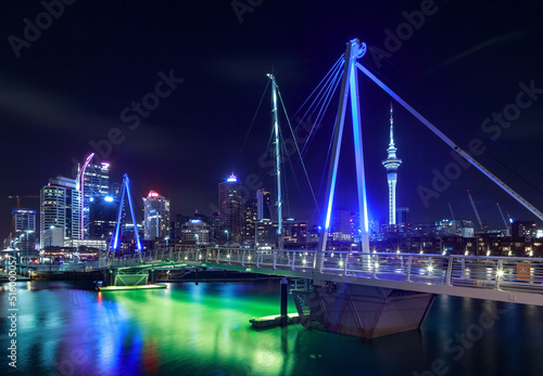 Auckland, New Zealand, at night, seen from the Viaduct Basin bridge. To the center right is the iconic Sky Tower