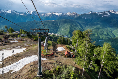 Cable car cabin rises up from Rosa Khutor village to Roza Peak mountain in Sochi resort.