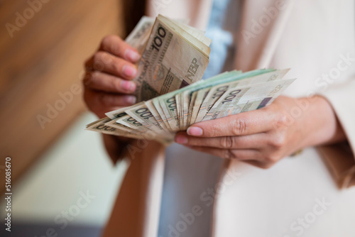 the girl holds in her hands banknotes money polish zlotys a salary for payment