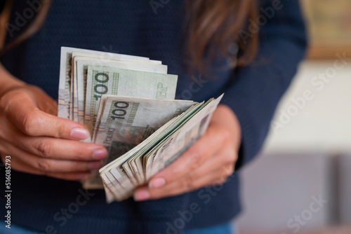 the girl holds in her hands banknotes money polish zlotys and pennies coins salary for payment