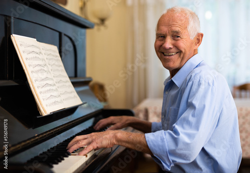 Senior man learning to play piano
