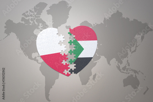 puzzle heart with the national flag of sudan and poland on a world map background.Concept.