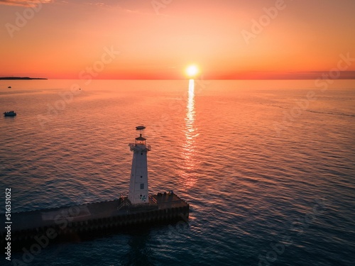 Bird's eye view of a lighthouse on a pier on Sodus Bay, New York at sunset