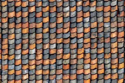 Red tiles background details, Old orange and dark brown roof brick under the sun, Shingles texture, Abstract geometric pattern, Roof top material.