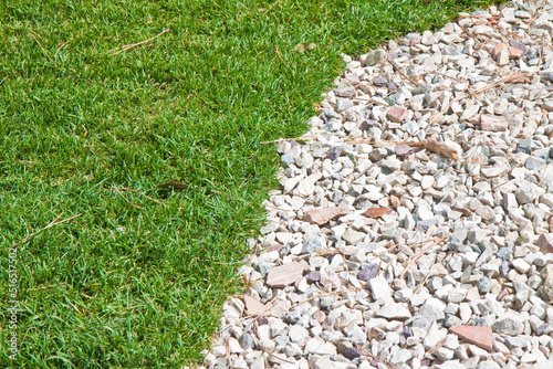 Detail of a beautiful green mowed lawn with white gravel