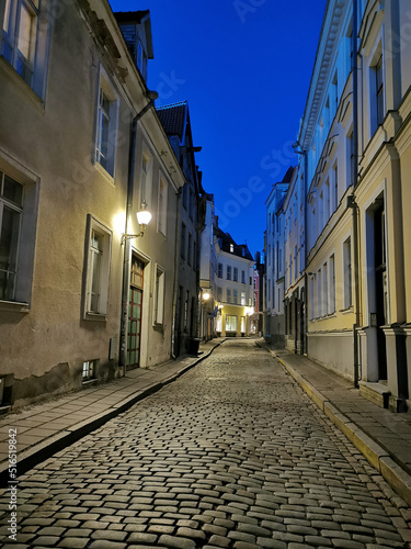 One of the narrow, cobbled streets of Old Tallinn against the blue sky. Spring evening.