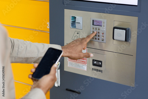 Man client using automated self service post terminal machine or locker. Mail shipping concept