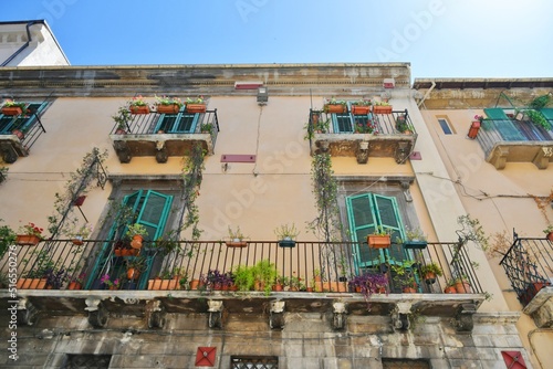 Balconies and windows of a house in the historic district of Sulmona, an Italian village in the Abruzzo region.