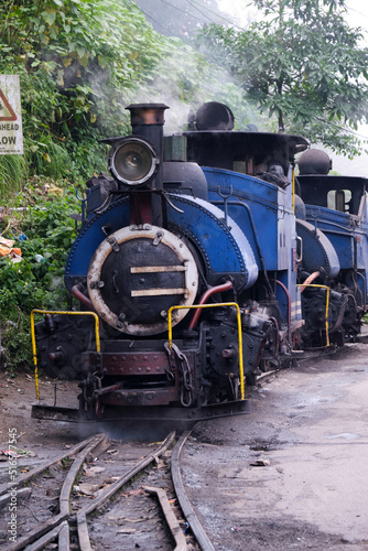 DARJEELING, INDIAN -June 22, The toy train of Darjeeling Himalayan Railway runs on the track in Darjeeling, India. Darjeeling Himalayan railway is a UNESCO world heritage site.