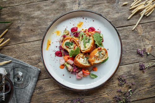 Top view on gourmet fried rolls dish on wooden background