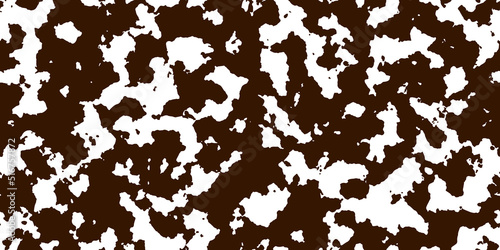 Brown cowhide with white spots as a seamless pattern. Spotted vector background. Animal print. Panda, dalmatian or appaloosa horse skin texture.