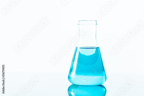 blue science experiment flask on white background