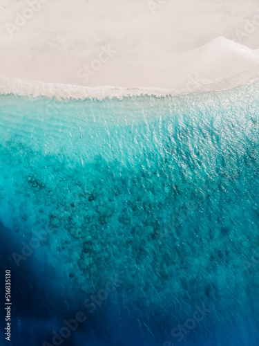 Beautiful tropical beach with blue crystal ocean and white sand, aerial view.
