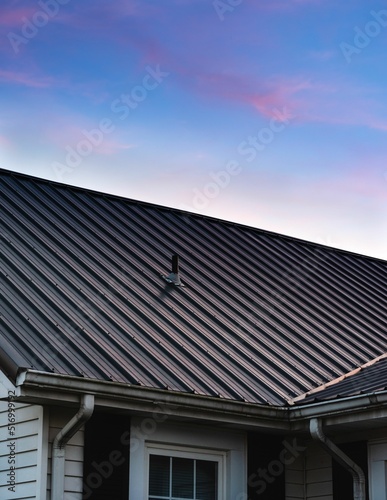 a beautiful house metal roof during the sunset