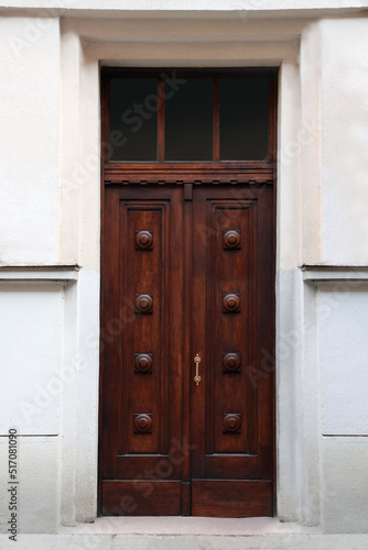 Entrance of house with beautiful wooden door and transom window