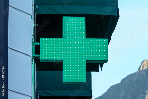 green cross illuminated led sign or signage indicating a pharmacy, dispensary or a chemist concept health and medical