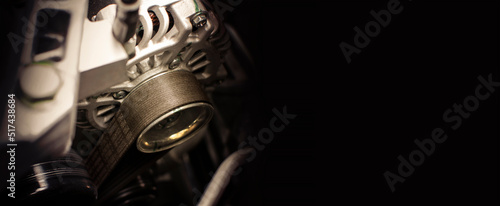 Automotive timing belt and alternator with a horizontal copy space on black background