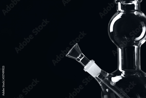 Closeup view of glass bong on black background, space for text. Smoking device