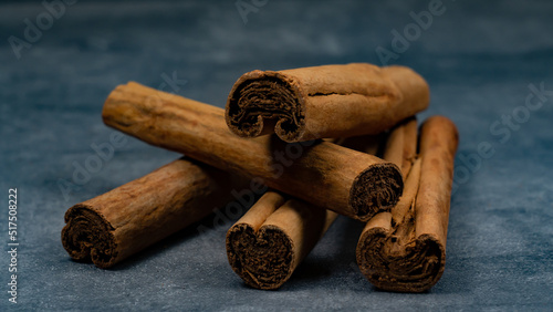 Ceylon cinnamon sticks lying on a stone background