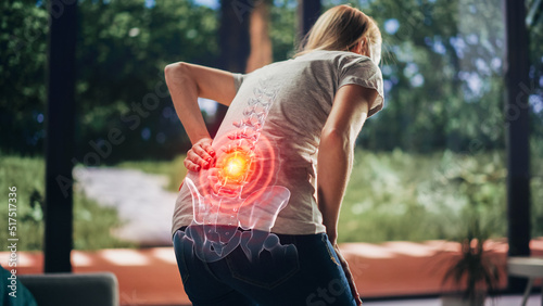 VFX Back Pain Augmented Reality Render. Close Up of a Female Experiencing Discomfort in a Result of Spine Trauma or Arthritis. Massaging and Stretching the Back to Ease the Injury.